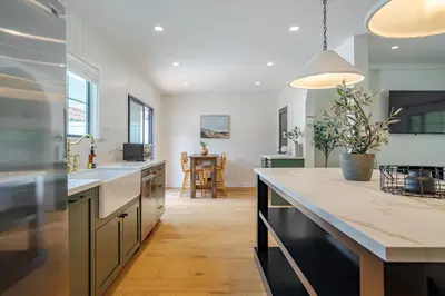 a kitchen with a large counter and a dining room at Designer 2 bed near Universal sleeps 8 hot tub in Los Angeles