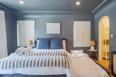 a bedroom with a large bed with blue walls at Designer 2 bed near Universal sleeps 8 hot tub in Los Angeles