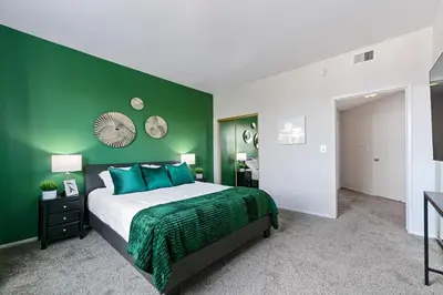 a green bedroom with a bed with a green wall at Beverly Hills Glamour Oasis 2 BR Apt with Parking 304 in Los Angeles