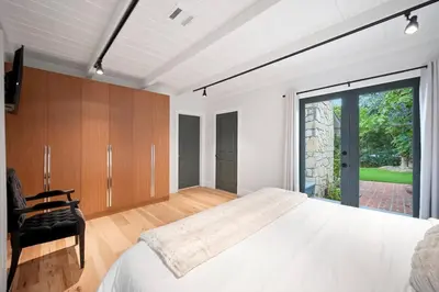 a bedroom with a large bed and a sliding glass door at Chic 3BR Oasis in Studio City:Toluca Lake Adjacent in Los Angeles