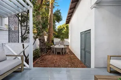 an outdoor patio with a table and a bench at Chic 3BR Oasis in Studio City:Toluca Lake Adjacent in Los Angeles