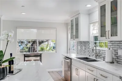 a white kitchen with a sink and a fireplace at Salt Water Pool Over Look Rocky Mountain View in Sierra Madre