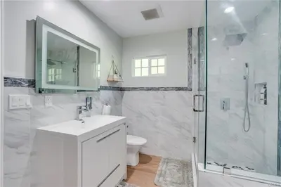a white bathroom with a sink and a shower at Salt Water Pool Over Look Rocky Mountain View in Sierra Madre