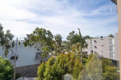 a view of a city with trees and buildings at Skyline Palms 1-Bedroom with Roof-Top Pool in Los Angeles