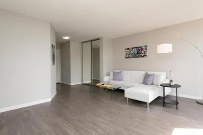 a living room with a white couch and a table at Skyline Palms 1-Bedroom with Roof-Top Pool in Los Angeles