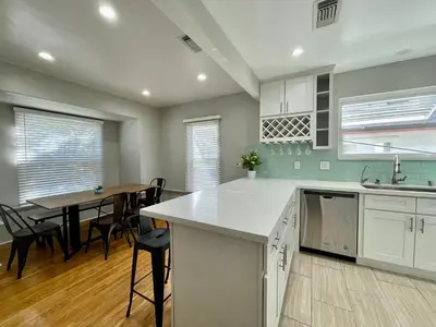 a kitchen and dining room with a table and chairs at 5 Mins Walk To Oldtown Monrovia Cozy 4 Br Home in Monrovia