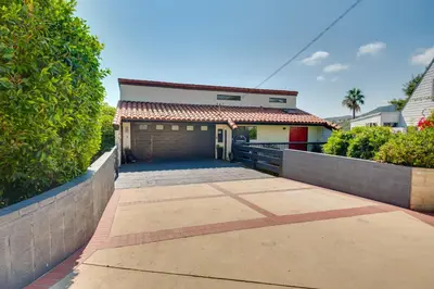 a house with a garage with a red door at Malibu Retreat with Balcony and Mountain Views in Malibu