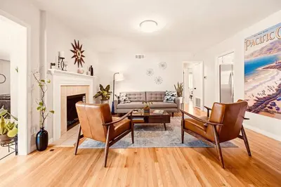 a living room with a couch and a table at Disneyland close FAMILY home! in Fullerton