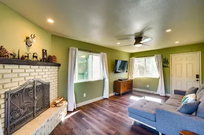 a living room with a couch and a fireplace at Running Springs Cabin with Spacious Deck and Hot Tub! in Running Springs