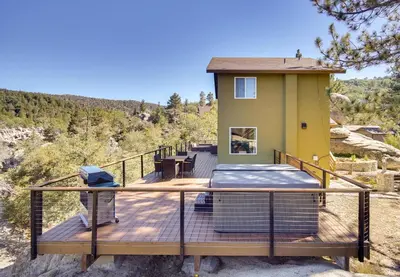a house on a deck with a view at Running Springs Cabin with Spacious Deck and Hot Tub! in Running Springs