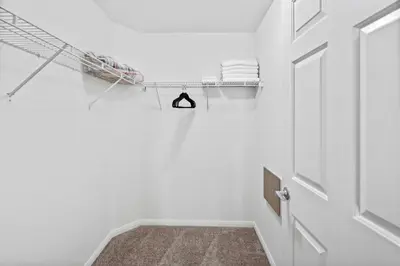 a hallway with a towel rack next to a door at Luxury 2BR/2BA! 5 MIN to Disney! in Anaheim