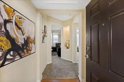 a hallway with a door and a painting on the wall at Luxury 2BR/2BA! 5 MIN to Disney! in Anaheim