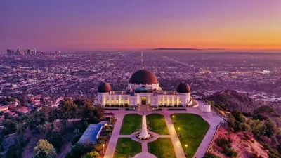 a building on a hill with a city in the background at Brand new Chic-Nest in Prime Location in Sherman Oaks