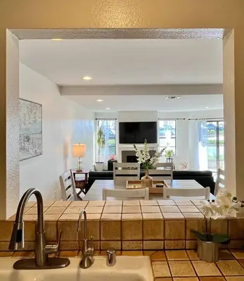 a kitchen with a sink and a living room at Beachfront Paradise in Port Hueneme