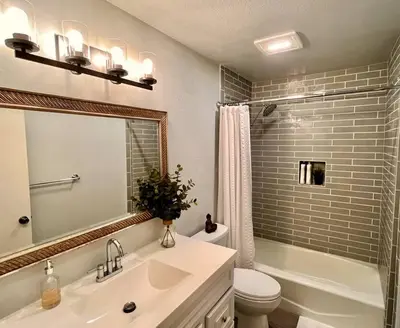 a bathroom with a sink and a toilet and a mirror at Beachfront Paradise in Port Hueneme