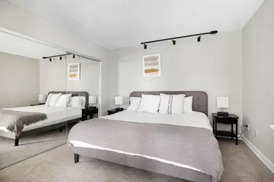 a white bedroom with two beds and two lamps at Redondo Beach 1BR w Pool Gym 1 block from beach LAX-438 in Redondo Beach