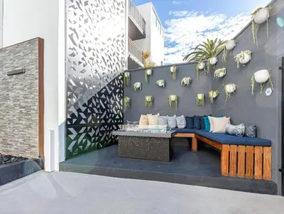 a patio with a blue couch against a wall at Redondo Beach 1BR w Pool Gym 1 block from beach LAX-438 in Redondo Beach