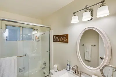 a bathroom with a shower and a sink and a mirror at 1 Mi to Lake Arrowhead Village! Cabin with Game Room in Lake Arrowhead