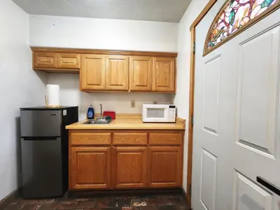 a kitchen with a black refrigerator and a microwave at Creek Runner's Lodge in Big Bear Lake
