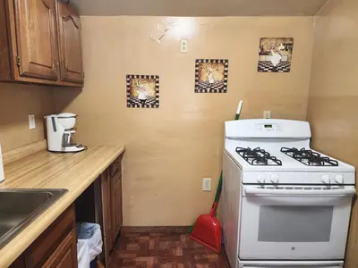 a kitchen with a white stove top oven next to a counter at Creek Runner's Lodge in Big Bear Lake