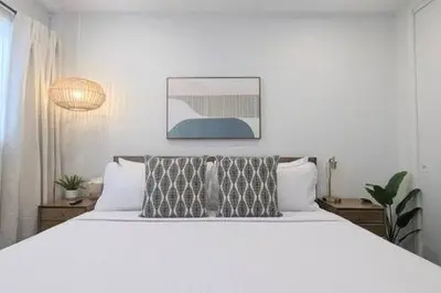 a bedroom with a large white bed with two pillows at Ocean View 1 Bedroom Manhattan Beach in Manhattan Beach