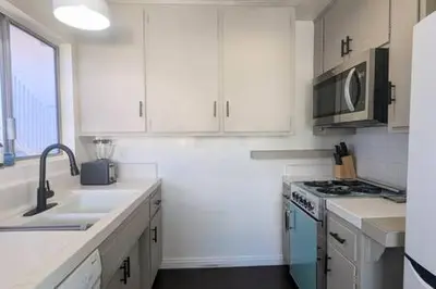 a white kitchen with a sink and a stove at Ocean View 1 Bedroom Manhattan Beach in Manhattan Beach