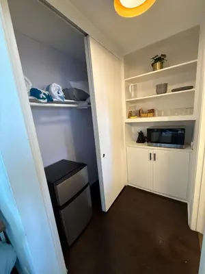 a small room with a white closet with a shelf at Ocean View Studio Manhattan Beach in Manhattan Beach