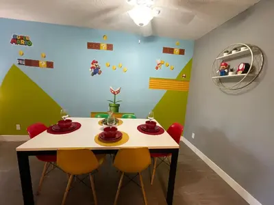 a dining room with a table and four chairs at Hollywood Apartments Mario & No Themed With Pool FREE parking and WIFI in Los Angeles