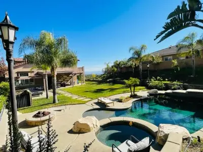 a swimming pool in a yard next to a house at Private-room-Private-entrance-spectacular-city-landscape-views-from-room in Rancho Cucamonga