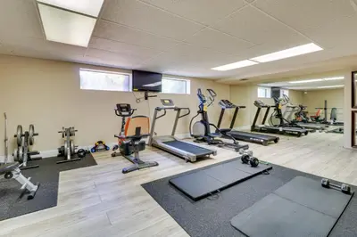 a gym with treadmills and cardio equipment in a room at Granada Hills Condo with Community Pool and Workspace in Los Angeles