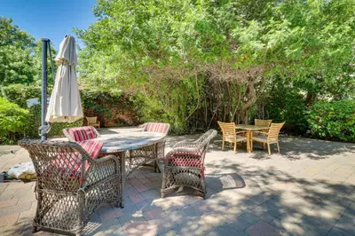 a patio with a table and chairs and an umbrella at Granada Hills Condo with Community Pool and Workspace in Los Angeles