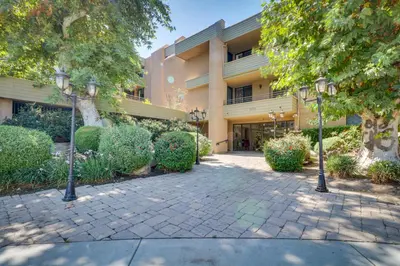 a building with two street lights in front of it at Granada Hills Condo with Community Pool and Workspace in Los Angeles