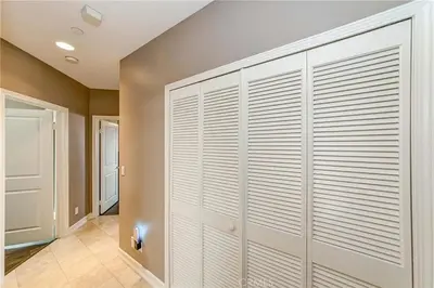 a hallway with white closet doors in a house at Redondo Beach Suite, 2 BR 1st floor Surf Gym workspace in Redondo Beach
