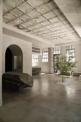 a large room with a rock in the middle of it at kodō hotel - Heart of LA Arts District in Los Angeles