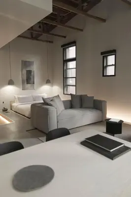 a living room with a couch and a table at kodō hotel - Heart of LA Arts District in Los Angeles
