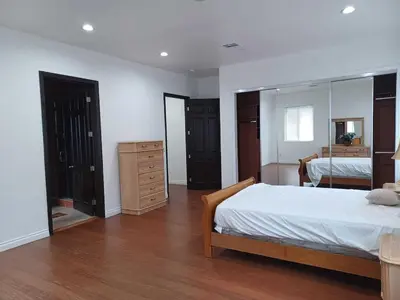 a bedroom with a bed and a dresser and a mirror at Achievers in Palmdale