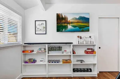 a room with white shelves and a painting on the wall at Modern Family Farmhouse with Pool, Jacuzzi, Putting Green, Treehouse, Bocce and more in Thousand Oaks