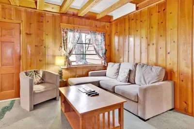 a living room with a couch and a table at Temple Lake Views Walk To Marina & Village Cabin in Big Bear Lake