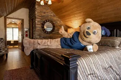 a teddy bear on a bed in a bedroom at How Sweet It Is~ Downtown Village Retreat Cabin~ Walk to Marinas and Shopping in Big Bear Lake