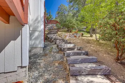 a set of stone steps next to a house at Lake Arrowhead Home with 3 Decks and Stunning Views! in Lake Arrowhead