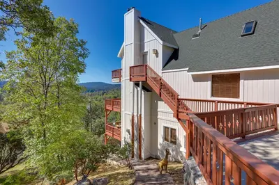 a house with a deck with a dog on it at Lake Arrowhead Home with 3 Decks and Stunning Views! in Lake Arrowhead