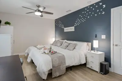 a bedroom with a large bed and a ceiling fan at LA Home - FIFA Soccer, NBA Games, Universal Studios in Los Angeles