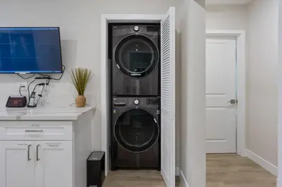 a kitchen with a washer and dryer in a room at LA Home - FIFA Soccer, NBA Games, Universal Studios in Los Angeles