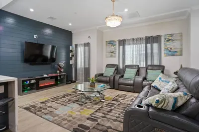 a living room with leather furniture and a flat screen tv at LA Home - FIFA Soccer, NBA Games, Universal Studios in Los Angeles