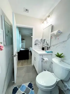 a white bathroom with a toilet and a sink at LA Home - FIFA Soccer, NBA Games, Universal Studios in Los Angeles