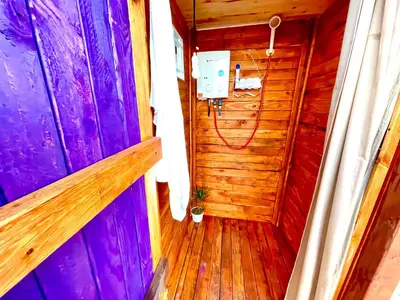 an inside view of a wooden room with purple and purple walls at Beysicair Tents & Campground in California City