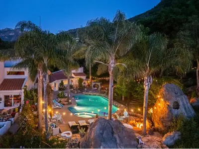 an outdoor swimming pool with palm trees and lights at The Malibu Retreat Guest House - Salt Water Pool & Jacuzzi, Nature Oasis in Calabasas
