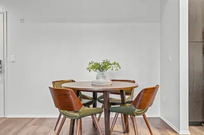 a dining room table with chairs and a vase of flowers at Luxury 2BDR with Parking & Pool - Marina del Rey in Los Angeles