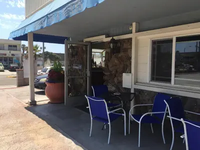 a table and chairs sitting outside of a restaurant at The Shores Inn in Ventura