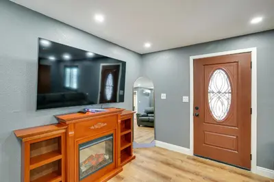 a living room with a television and a door at Hidden Gem in Hawthorne about 3 Mi to SoFi Stadium in Hawthorne